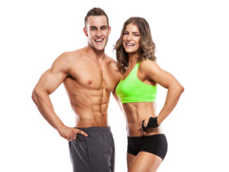 Beautiful young sporty couple isolated over white background