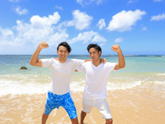 Happy young men on a tropical beach