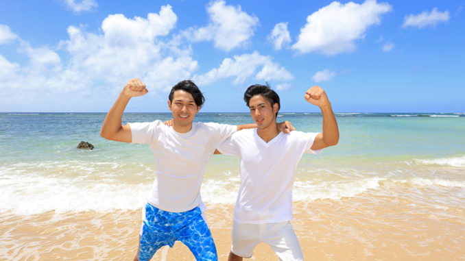 Happy young men on a tropical beach