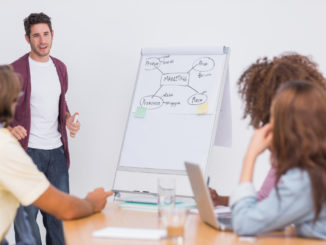 Man presenting to his creative team in the office