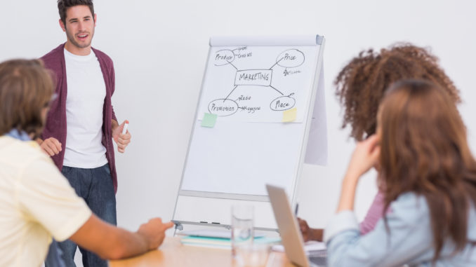 Man presenting to his creative team in the office