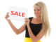 Young beautiful woman with sale sign on a white background.
