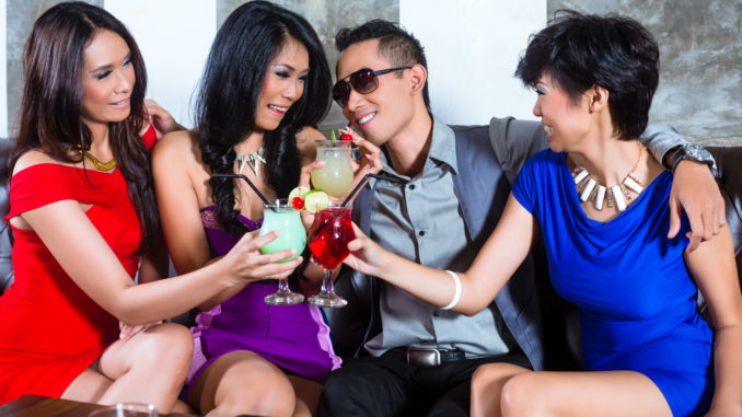 Asian young and handsome party people men flirting with women in fancy night club