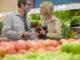 Couple choosing apples in grocery store