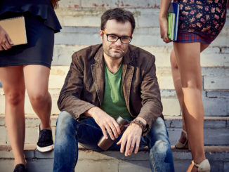 A young man and two girls on the stairs