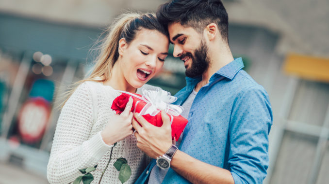Romantic Man giving flower and gift box to women for Valentines day