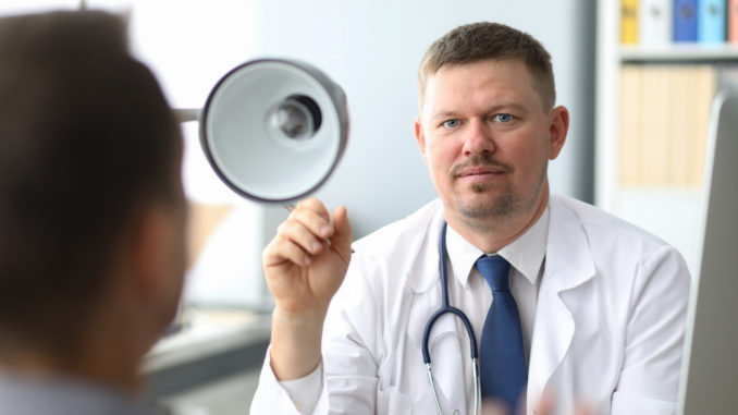 Doctor listening to the patient while he is telling about his problems. Just hands over the table.