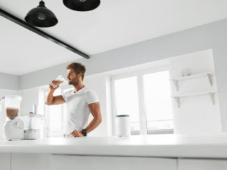 Handsome Happy Smiling Man With Muscular Body Drinking Protein Shake Before Workout.