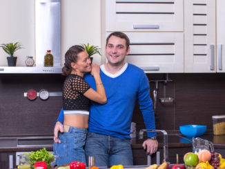 Young happy couple in the kitchen