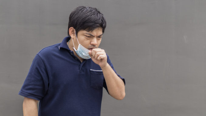 Asian man in the street wearing protective masks., Sick man with flu wearing mask