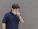 Asian man in the street wearing protective masks., Sick man with flu wearing mask
