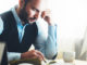 Bearded young businessman working on modern office.