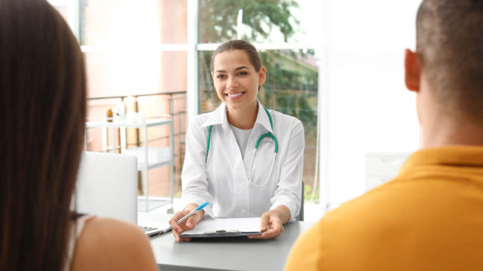 Doctor talking to her patients in hospital