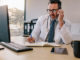 Medicine professional talking on phone and writing in his diary