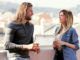 Shot of pretty young couple talking while drinking beer on the rooftop at home
