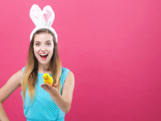 Young woman with Easter theme on a pink background