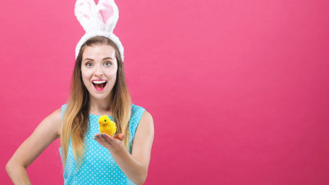 Young woman with Easter theme on a pink background