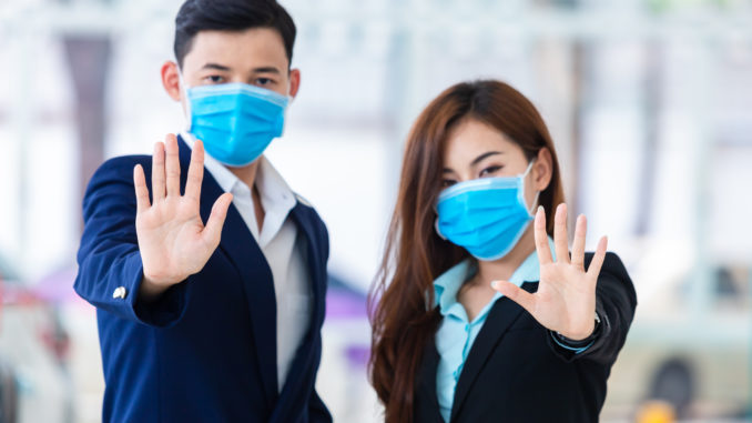 [Covid-19] Coronavirus concept.man and women wearing mask for protect pm2.5 and show stop hands gesture for stop Covid-19 outbreak.Wuhan coronavirus and epidemic virus symptoms.