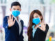 [Covid-19] Coronavirus concept.man and women wearing mask for protect pm2.5 and show stop hands gesture for stop Covid-19 outbreak.Wuhan coronavirus and epidemic virus symptoms.