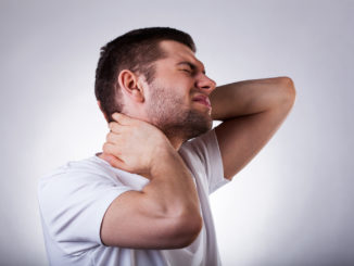 Young exhausted man with strong neck ache isolated on white background