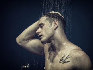 Close up Attractive Young Bare Muscular Young Man Taking Shower, with Eyes Closed