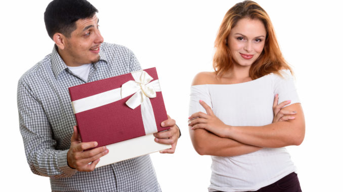 men looking at women while opening gift box looking surprised