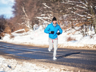 Active man, jogging and running during a sunny winter day. Outdoor working out concept