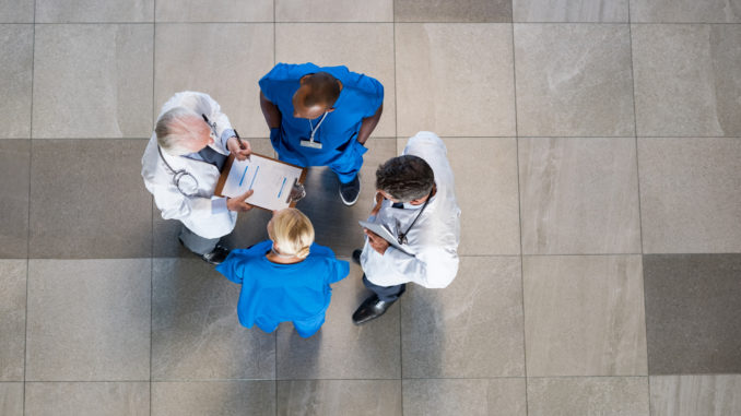 Doctors and nurses talking to each other about medical results.