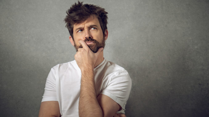 Funny portrait man thinking with funny face long hair and beard on isolated background