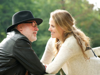 Portrait of a mature men with young women smiling at each other