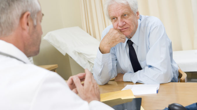 Man in doctor s office frowning