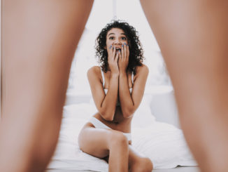 Young Beautiful Couple in Underwear in Bedroom.