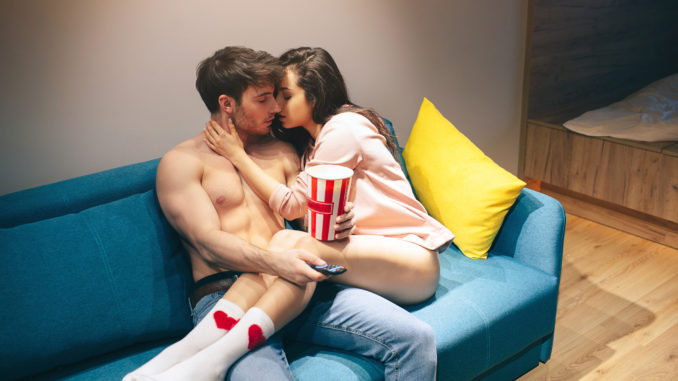 Young couple have intimacy in kitchen in night.