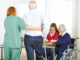 Senior people in nursing home with geriatric garegiver
