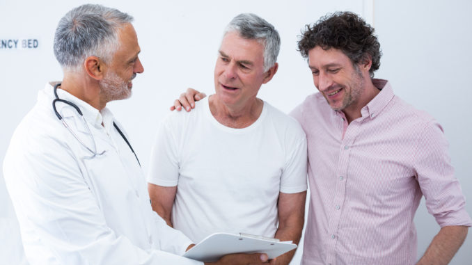 Senior men and his guardian talking to the doctor in hospital