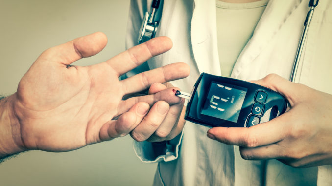 Doctor checking blood sugar level with glucometer - diabetes and glicemia concept - retro style