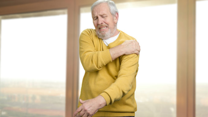 Old senior man with shoulder pain.