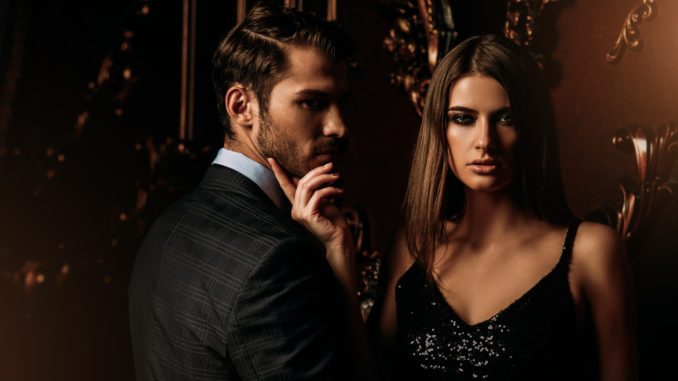 Sexual passionate couple in elegant evening dresses. Luxurious interior. Fashion shot.