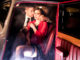 Good looking couple, handsome men in suit, beatiful women in red dress, touching, holding each other passionately in vintage car