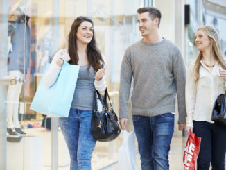 Group Of Friends Shopping In Mall Together