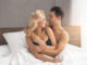Young couple men and women intimate relationship on bed hugging