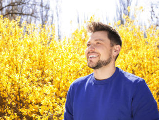 Happy healthy man enjoying springtime outdoors