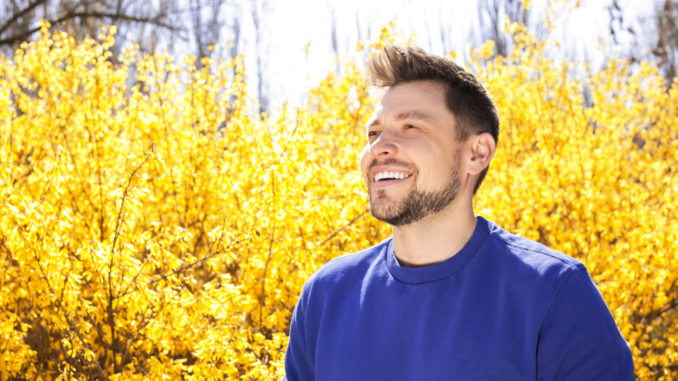 Happy healthy man enjoying springtime outdoors