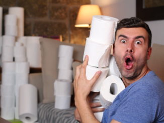 Man stocking up toilet paper at home.