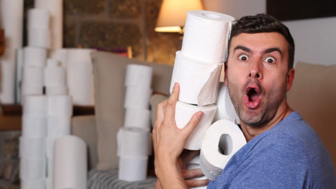 Man stocking up toilet paper at home.