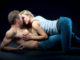 Young couple lying on the floor. Woman on top men put a hand on his chest.
