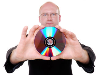 A man holding a CD on an isolated white background.
