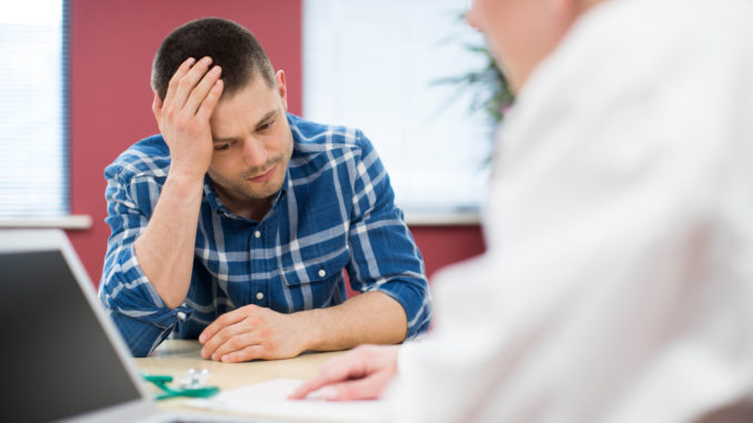 Worried Man Meets With Female Doctor In Surgery