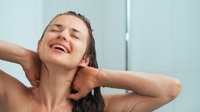 Portrait of relaxed young woman taking shower