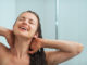 Portrait of relaxed young woman taking shower